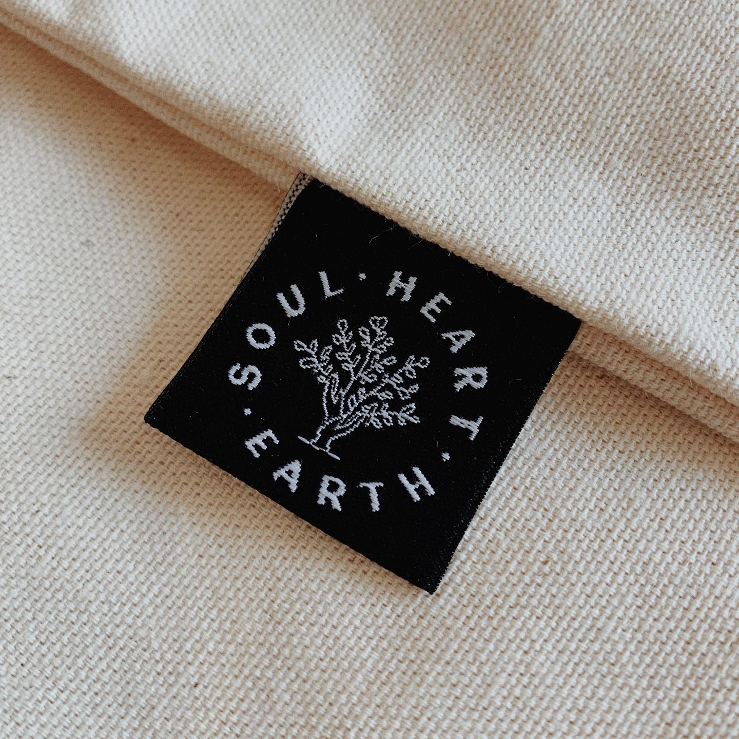 Beautiful woven cotten label of the SHE Logo